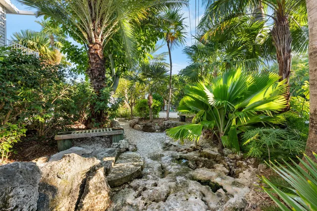a couple of palm trees in front of yellow building