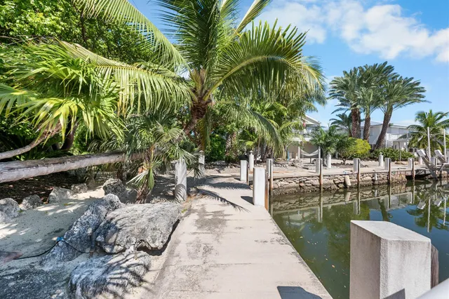 a front view of a house with plants