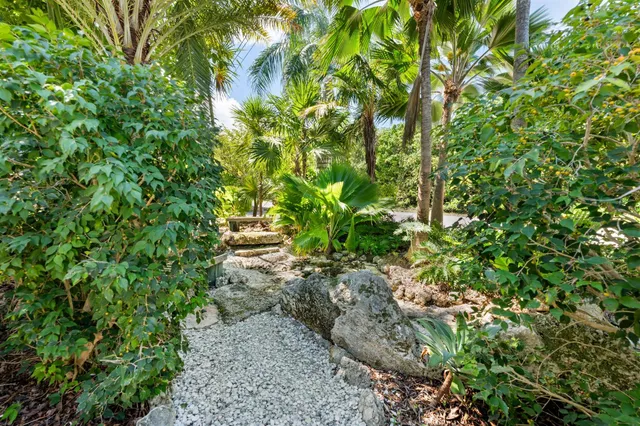 a view of a hallway with stairs and a white door