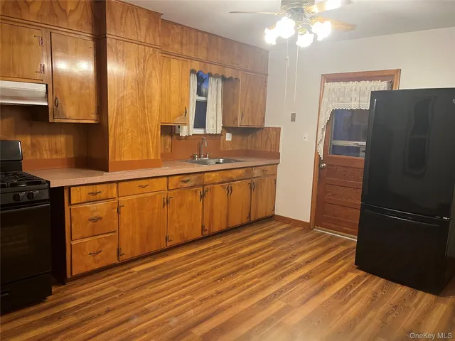 a kitchen with stainless steel appliances granite countertop a refrigerator and a sink