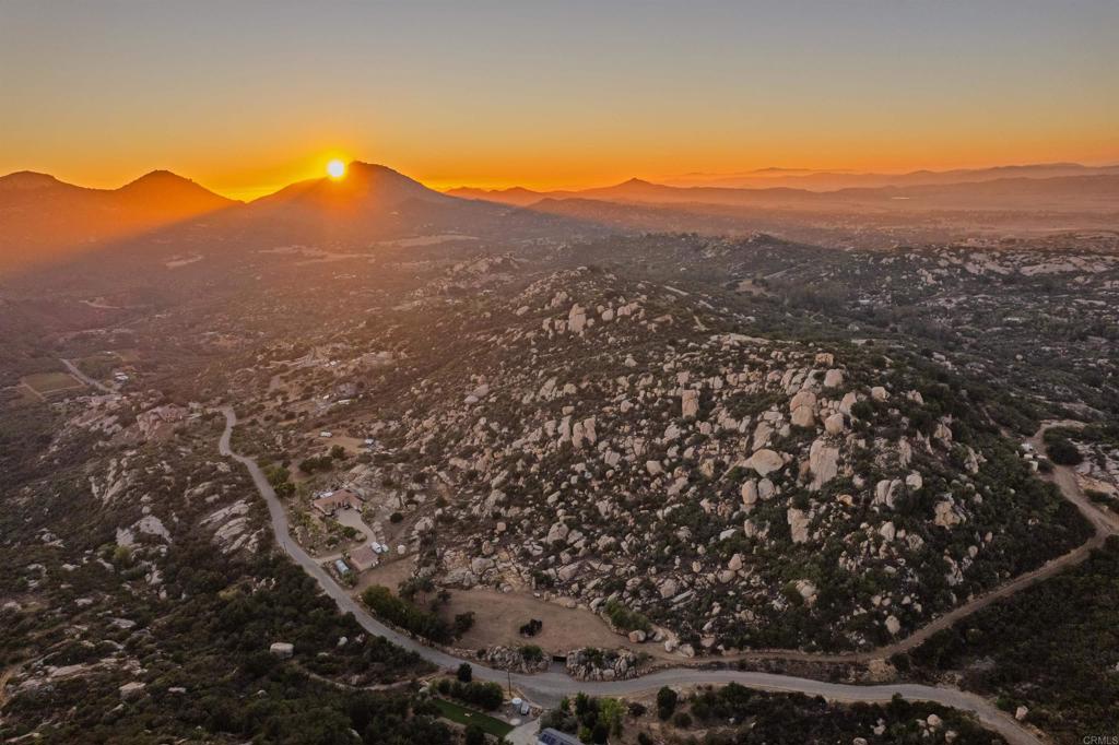 a view of a mountain range in front of a house