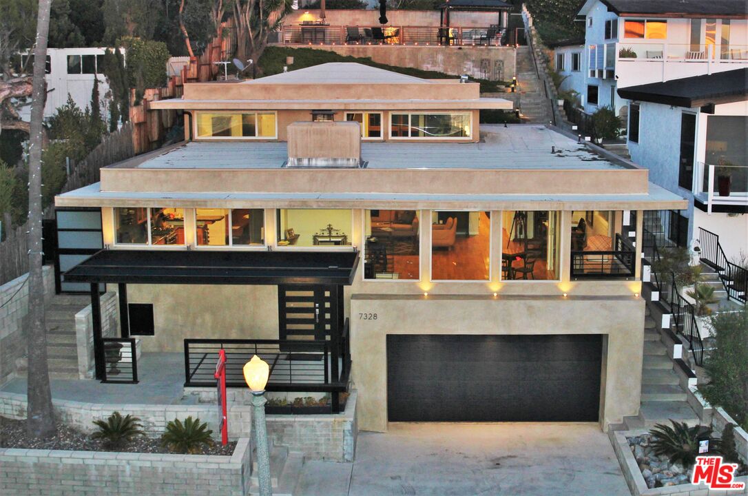 a front view of a house with a parking space