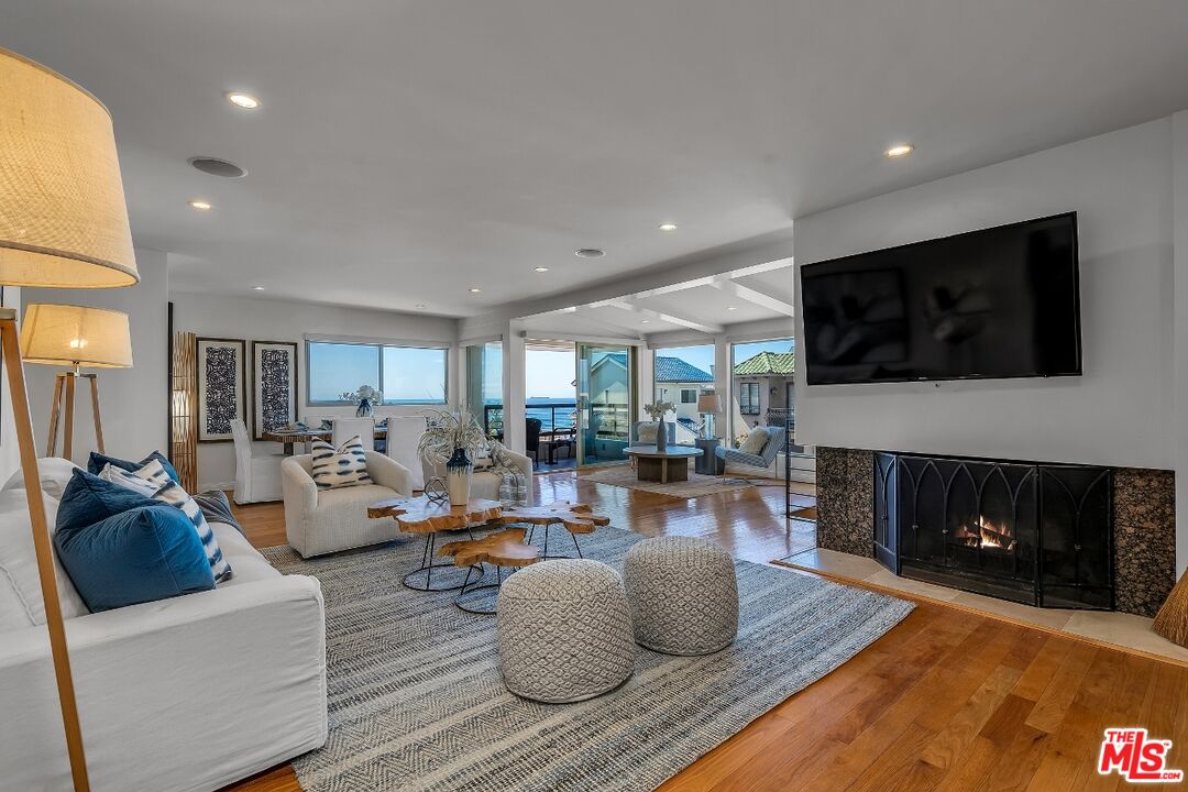 7328 Vista Del Mar Lane Playa del Rey, CA 90293 - Photo 12 of 56 a living room with furniture a flat screen tv and a fireplace