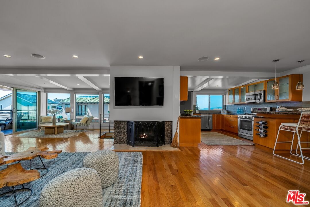 7328 Vista Del Mar Lane Playa del Rey, CA 90293 - Photo 13 of 56 a living room with fireplace furniture and a wooden floor