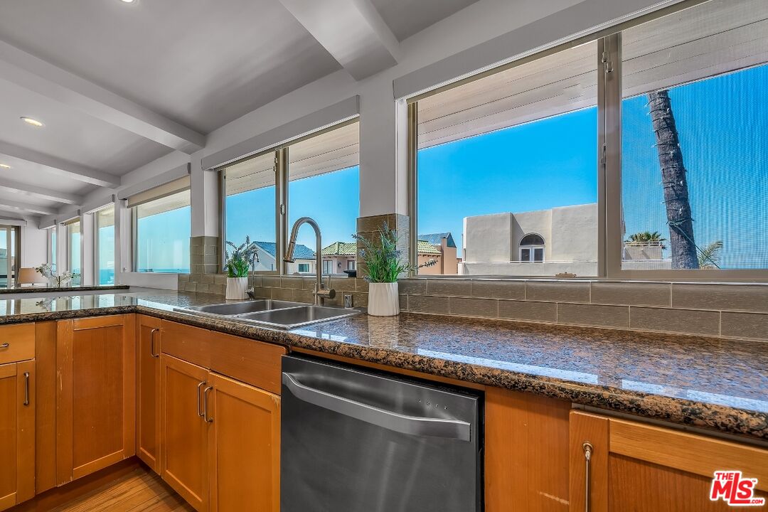 7328 Vista Del Mar Lane Playa del Rey, CA 90293 - Photo 17 of 56 a kitchen with stainless steel appliances granite countertop a sink a stove and a microwave