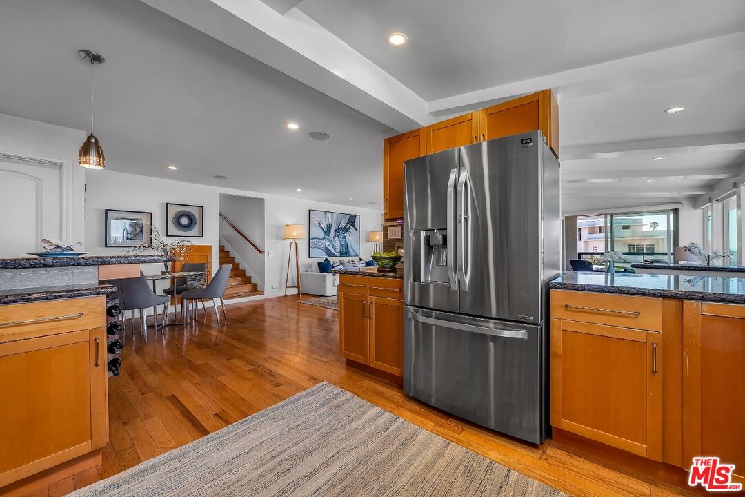 7328 Vista Del Mar Lane Playa del Rey, CA 90293 - Photo 21 of 56 a kitchen with stainless steel appliances granite countertop a refrigerator stove top oven and wooden floor