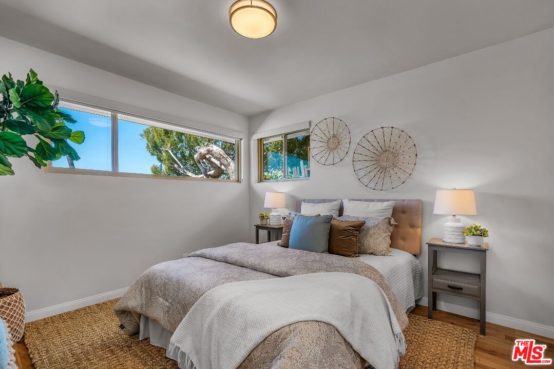 7328 Vista Del Mar Lane Playa del Rey, CA 90293 - Photo 26 of 56 a bedroom with a bed and a potted plant