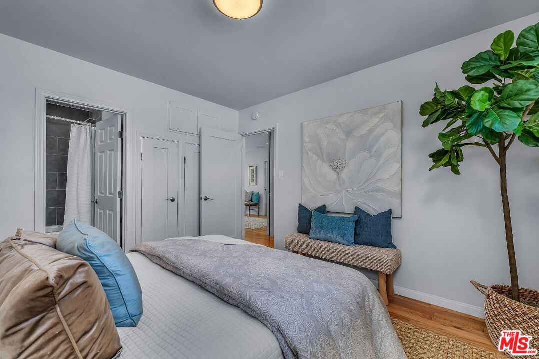 7328 Vista Del Mar Lane Playa del Rey, CA 90293 - Photo 27 of 56 a bedroom with bed and a potted plant