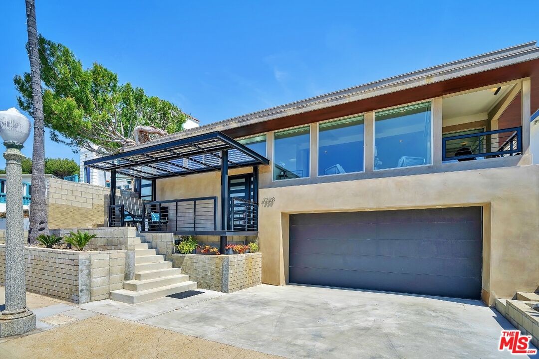 7328 Vista Del Mar Lane Playa del Rey, CA 90293 - Photo 3 of 56 a front view of a house with a garage