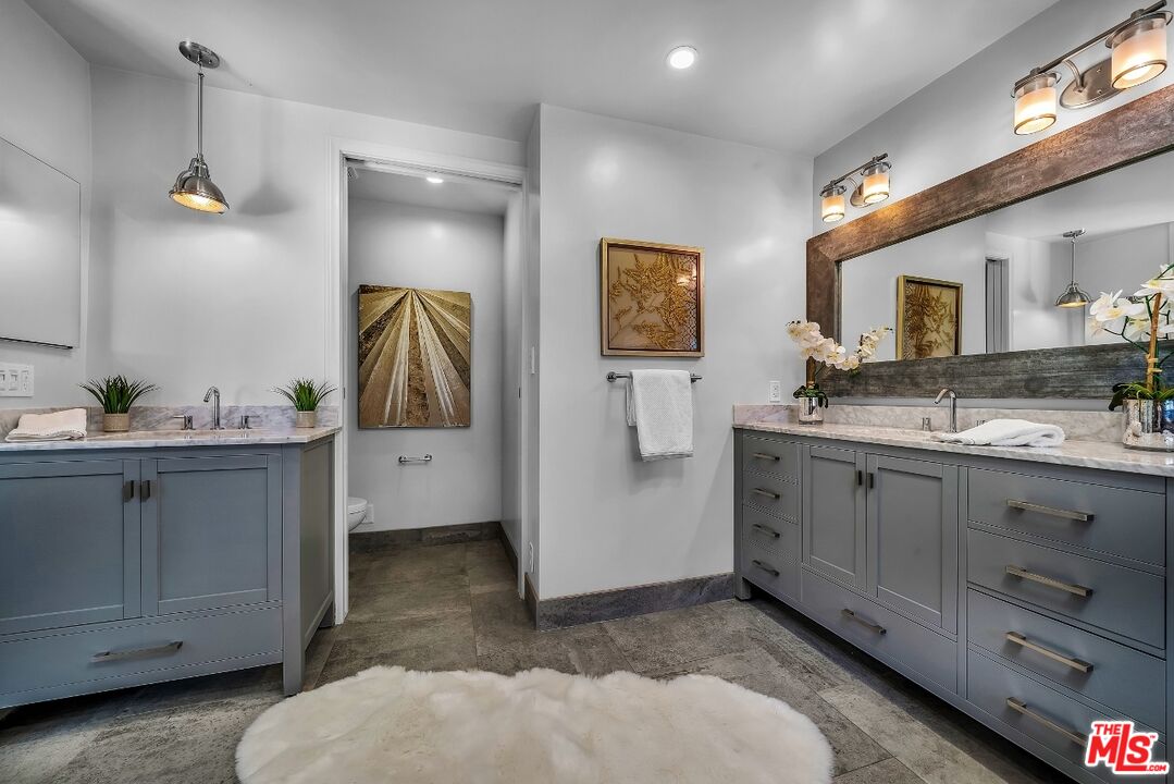 7328 Vista Del Mar Lane Playa del Rey, CA 90293 - Photo 41 of 56 a spacious bathroom with a double vanity sink and a mirror
