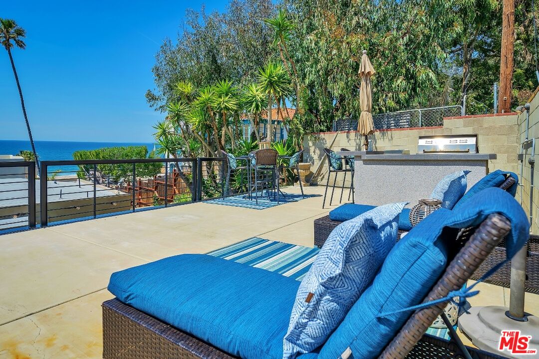7328 Vista Del Mar Lane Playa del Rey, CA 90293 - Photo 47 of 56 a view of a patio with table and chairs potted plants with wooden floor