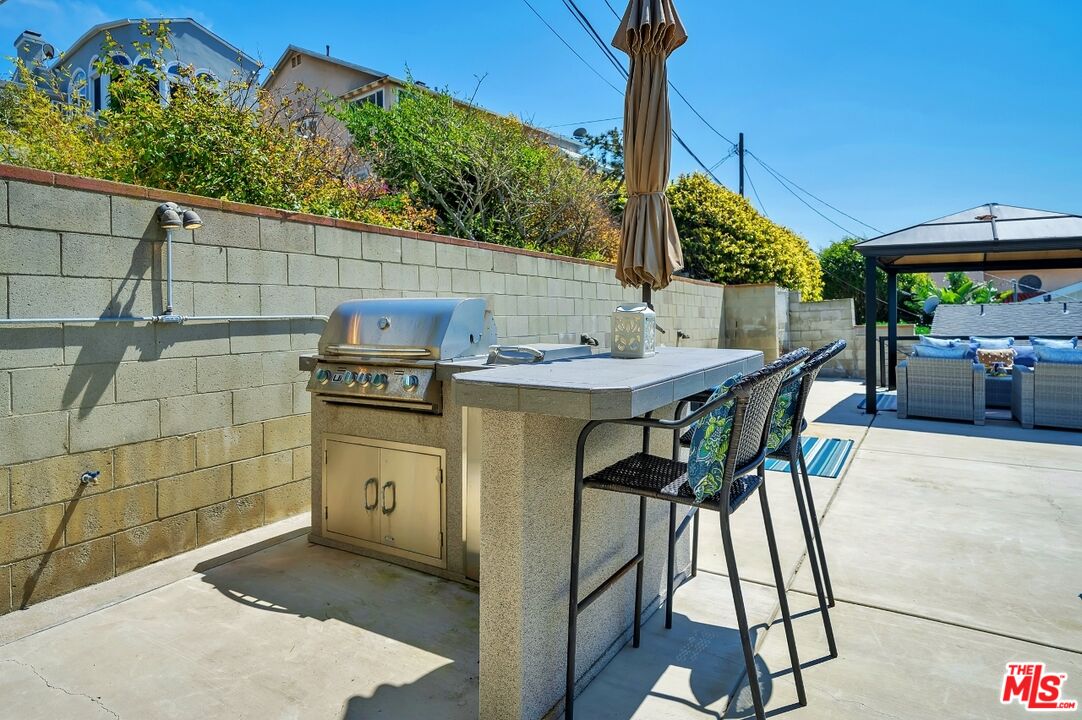 7328 Vista Del Mar Lane Playa del Rey, CA 90293 - Photo 48 of 56 a view of a patio with table and chairs a fire pit with wooden fence