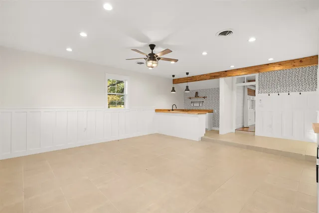wooden floor in an empty room with a ceiling fan