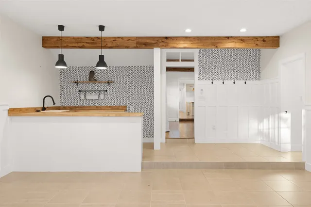 an empty room with windows and cabinet