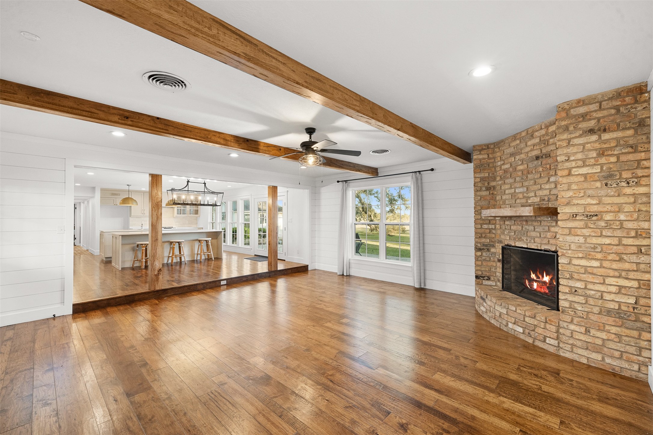 351 Pleasant Hill School Road Brenham, TX 77833 - Photo 10 of 46 a view of an empty room with wooden floor fireplace and a window