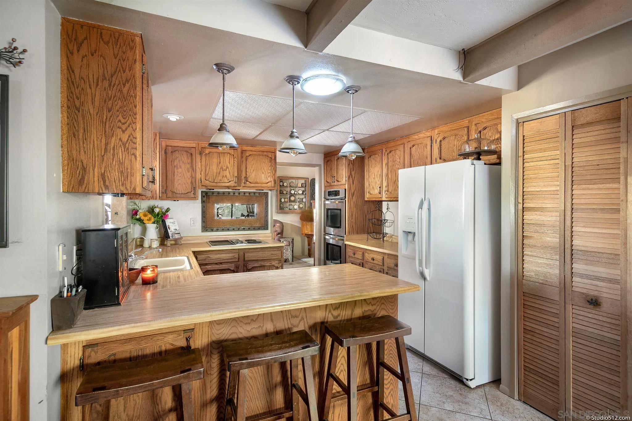 4944 Mountainbrook Road Santa Ysabel, CA 92070 - Photo 12 of 29 a kitchen with refrigerator a sink and cabinets