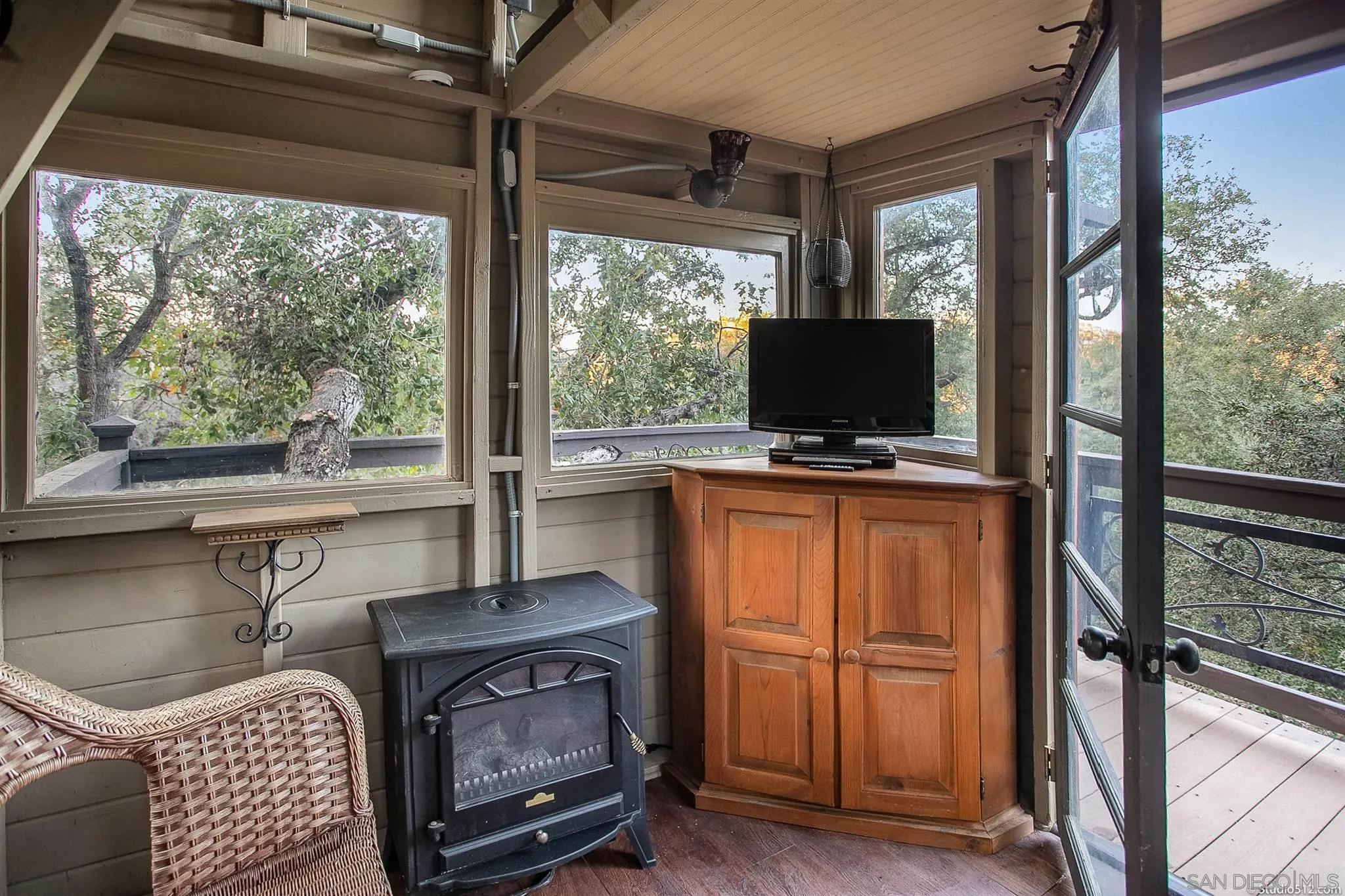 4944 Mountainbrook Road Santa Ysabel, CA 92070 - Photo 29 of 29 a living room with furniture a flat screen tv and a floor to ceiling window