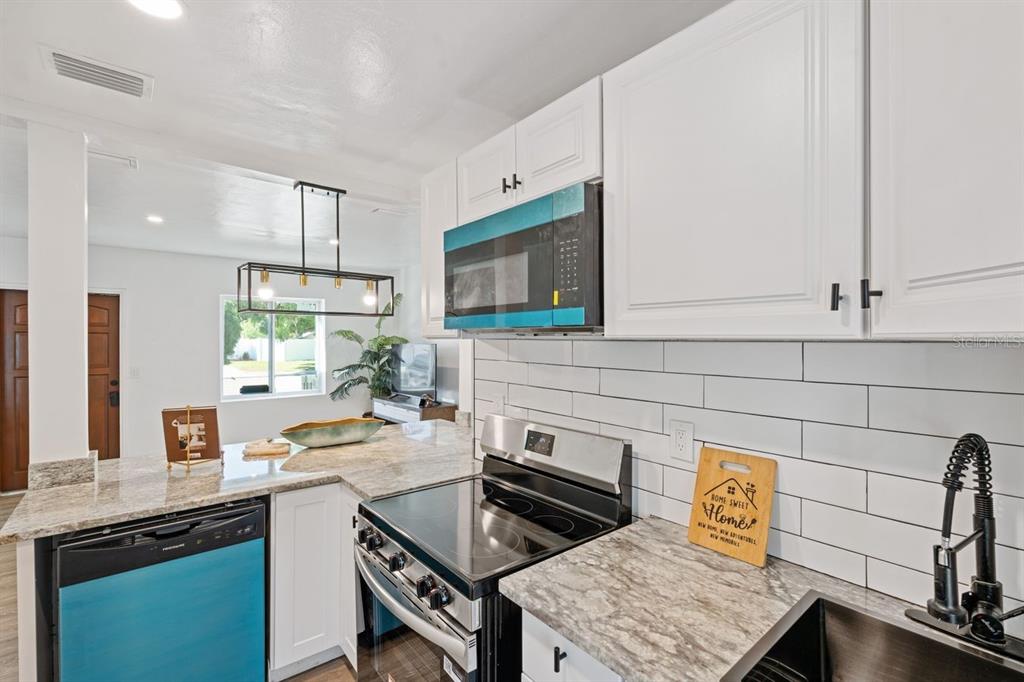 4635 22nd Avenue North St. Petersburg, FL 33713 - Photo 6 of 20 a kitchen with a sink stove and cabinets