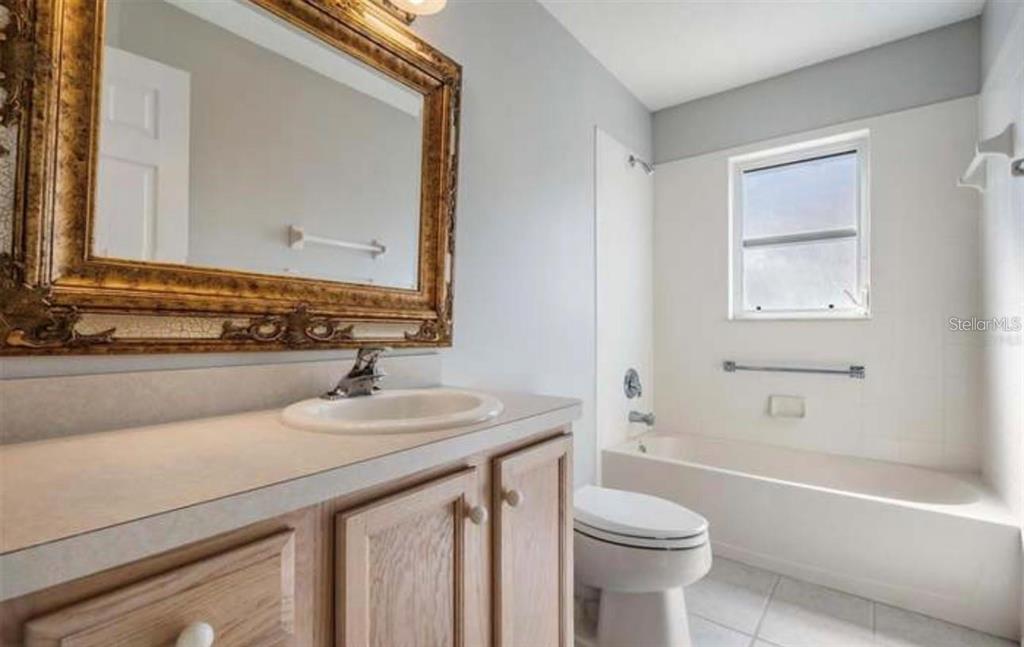 1520 Canberley Court Trinity, FL 34655 - Photo 15 of 35 a bathroom with a sink a toilet and shower