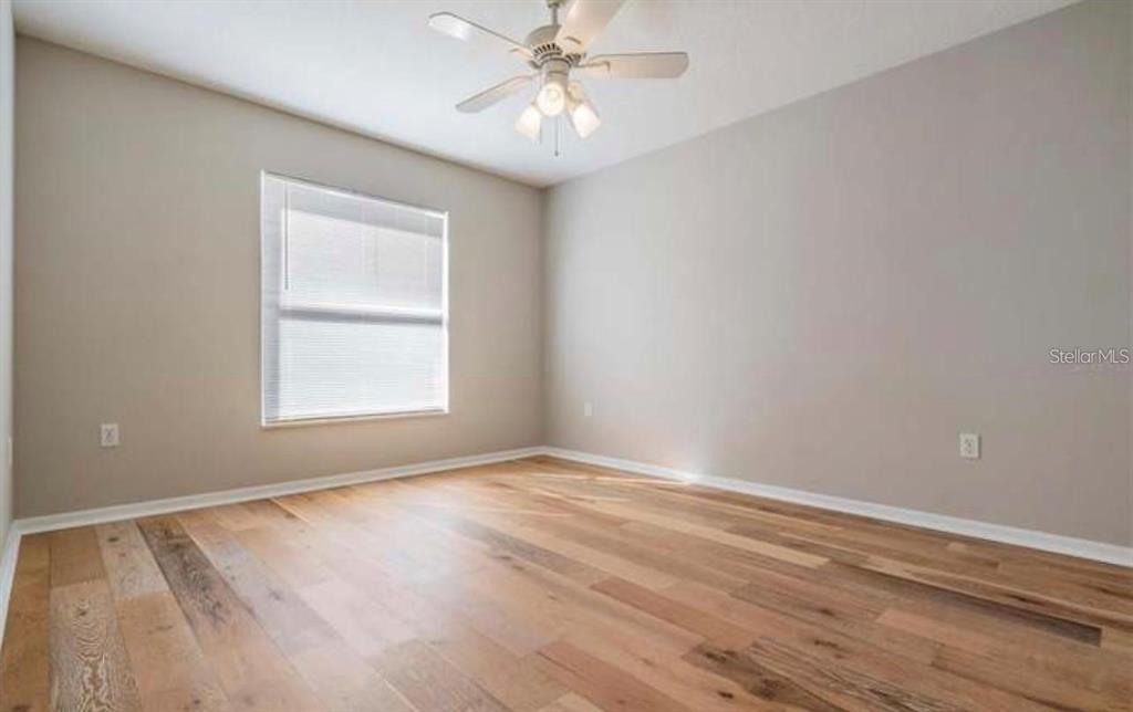 1520 Canberley Court Trinity, FL 34655 - Photo 16 of 35 wooden floor in an empty room with a window
