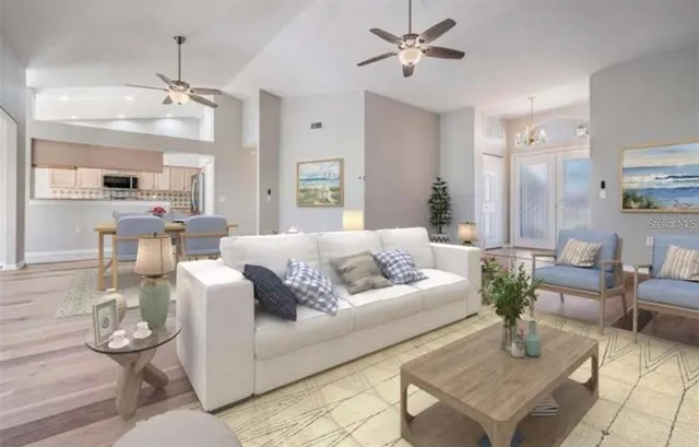 a living room with furniture and kitchen view