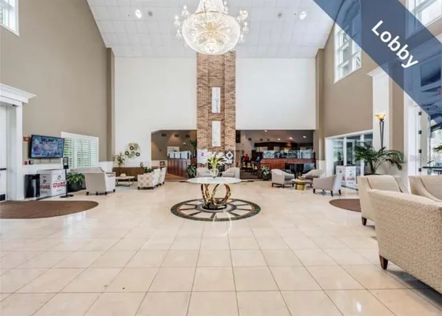 a room with lots of tables a large window and chairs