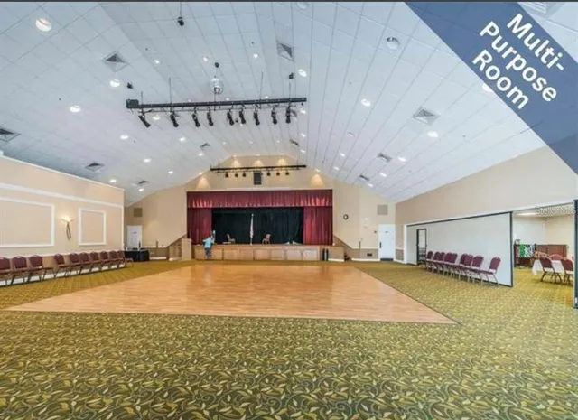 a view of swimming pool with outdoor seating and lake view