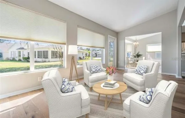 a dining room with wooden floor a chandelier a wooden table and chairs