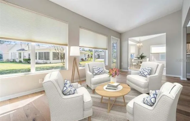 a dining room with wooden floor a chandelier a wooden table and chairs