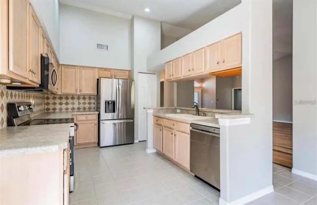 a kitchen with stainless steel appliances granite countertop a sink stove and cabinets