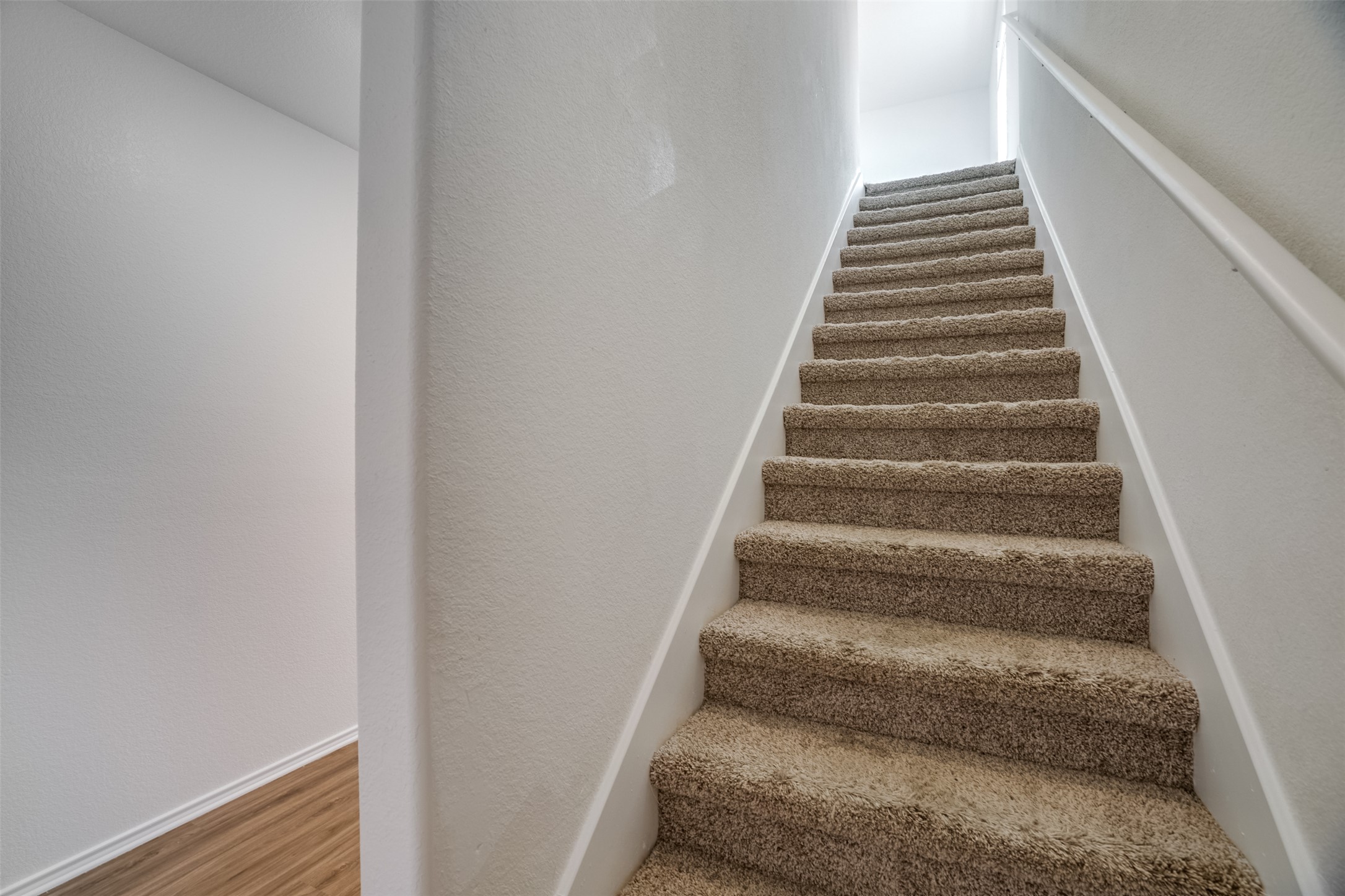 428 Gabbro Gardens Maxwell, TX 78656 - Photo 8 of 26 Stairs with a textured wall and wood finished floors