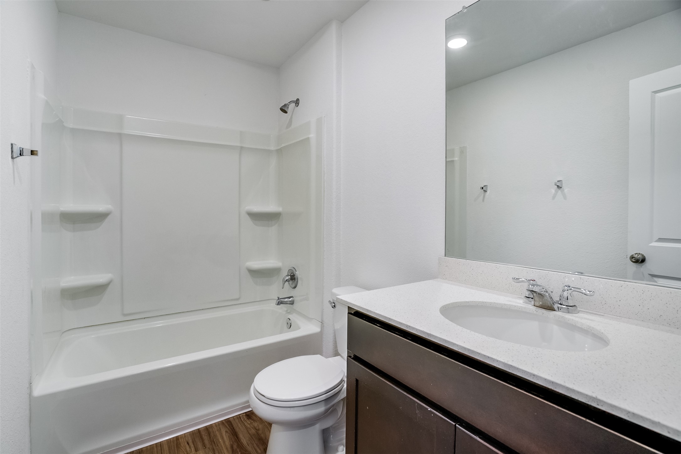 428 Gabbro Gardens Maxwell, TX 78656 - Photo 17 of 26 Bathroom with vanity, dark wood-style flooring, and washtub / shower combination