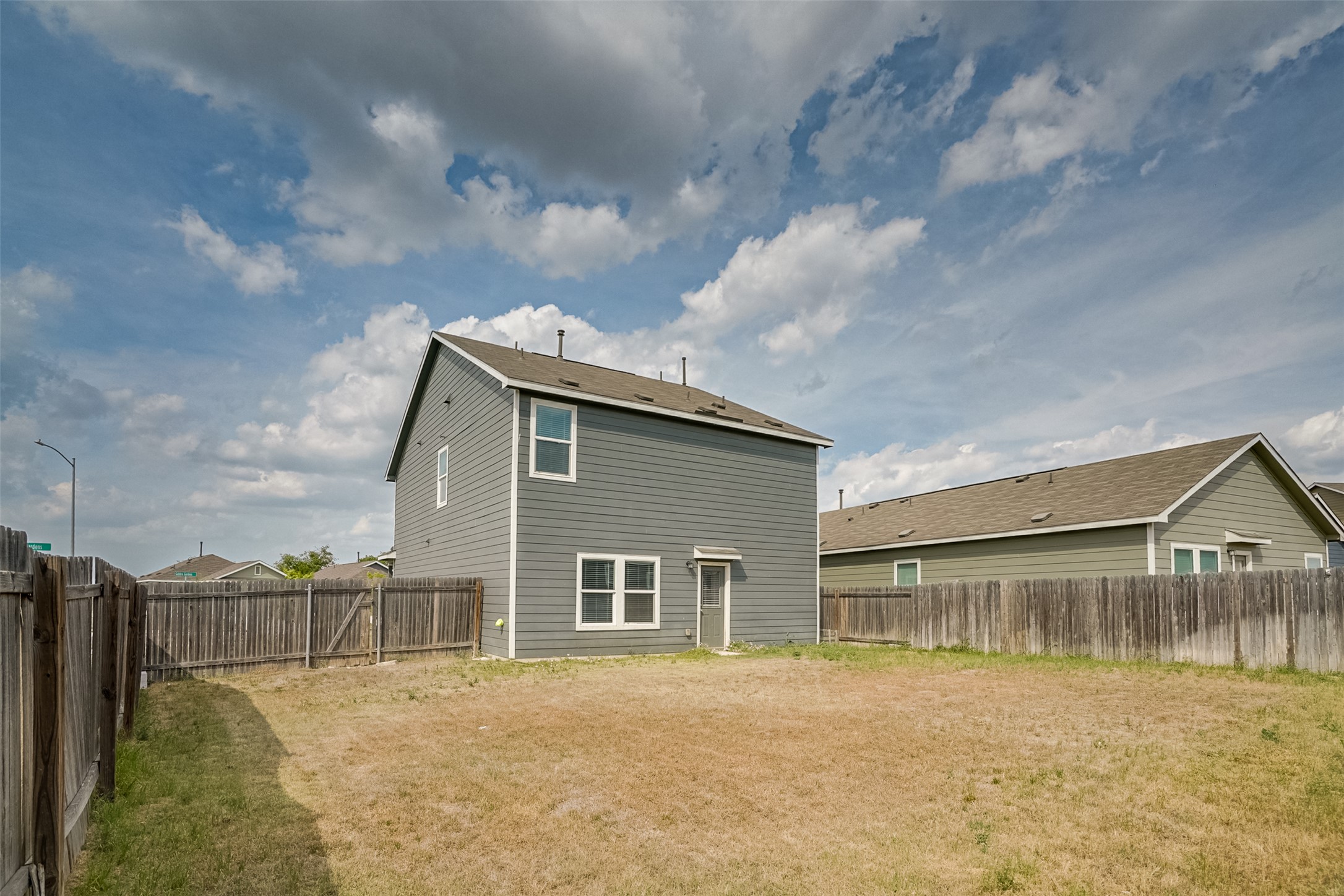 428 Gabbro Gardens Maxwell, TX 78656 - Photo 21 of 26 Back of house with a fenced backyard