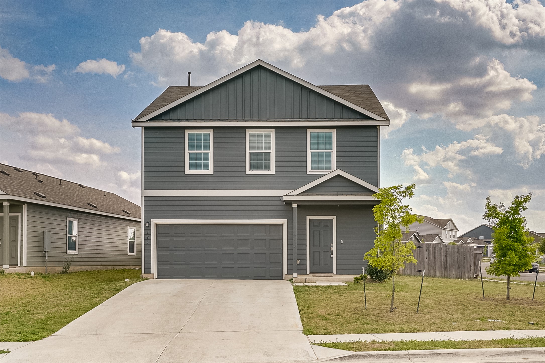 428 Gabbro Gardens Maxwell, TX 78656 - Photo 3 of 26 View of front facade featuring driveway and an attached garage