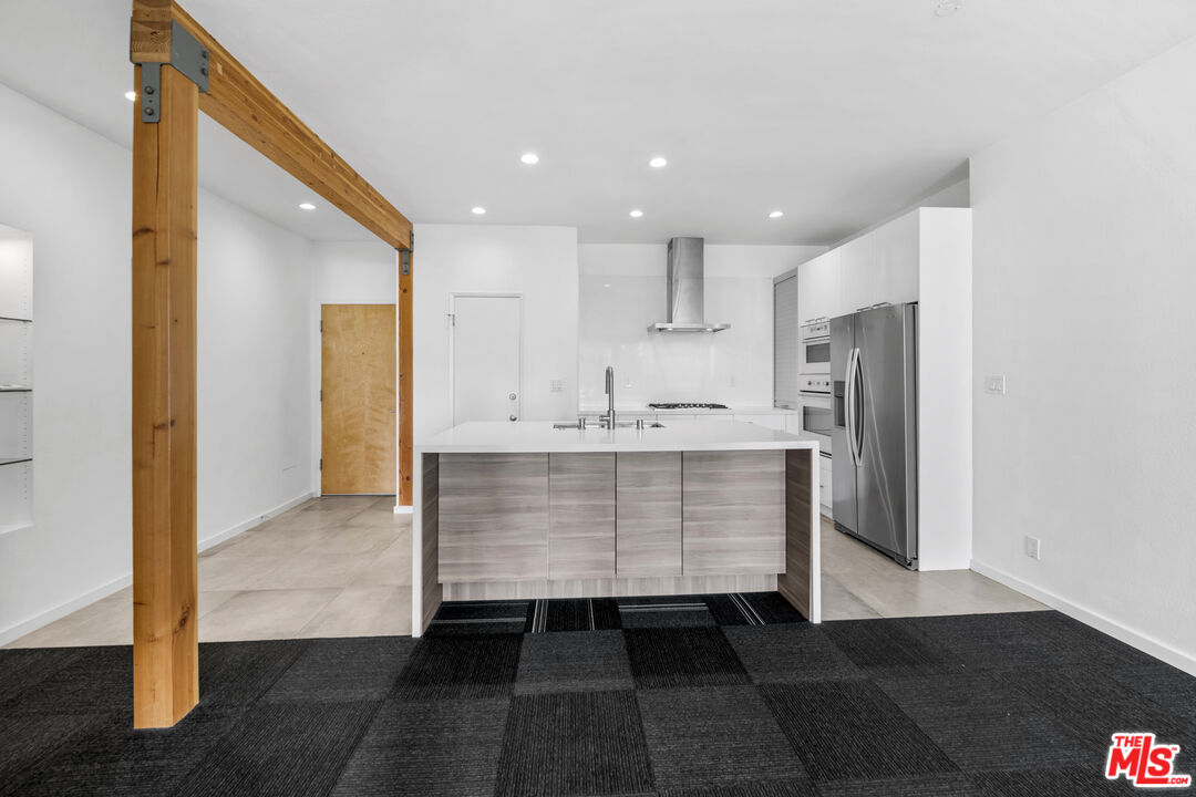 2221 Ocean Avenue, Unit 205 Santa Monica, CA 90405 - Photo 5 of 16 a view of kitchen with refrigerator and wooden floor