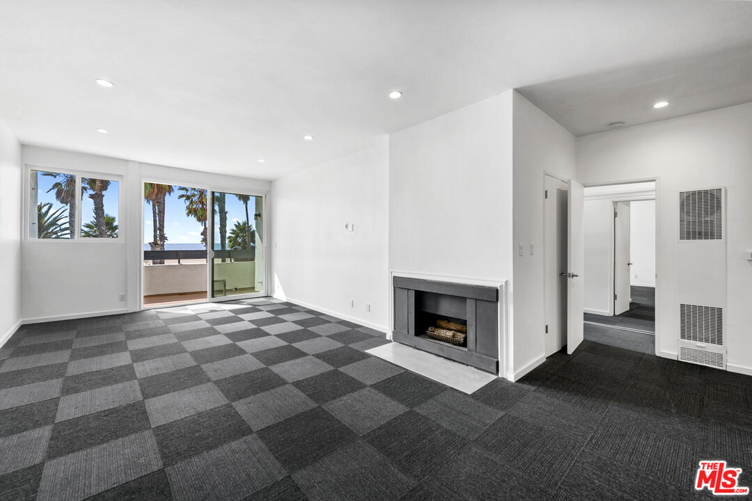 2221 Ocean Avenue, Unit 205 Santa Monica, CA 90405 - Photo 7 of 16 a view of a livingroom with an empty space and a fireplace