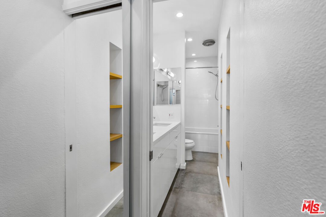 2221 Ocean Avenue, Unit 205 Santa Monica, CA 90405 - Photo 9 of 16 a bathroom with a granite countertop sink and shower