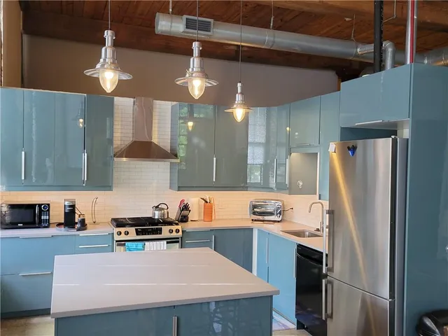 a kitchen with refrigerator a stove a sink and a refrigerator