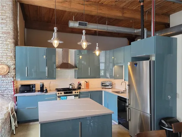 a kitchen with stainless steel appliances a refrigerator and a stove