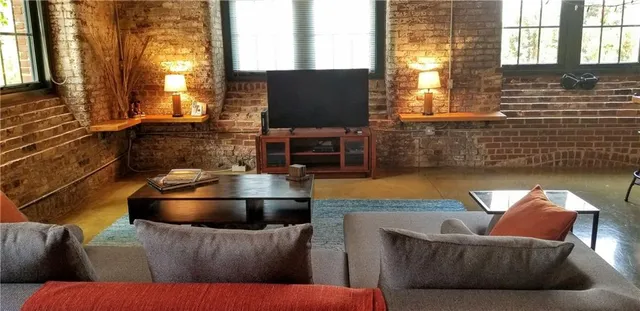 a living room with couches and a flat screen tv