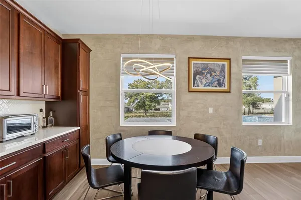 a living room with furniture kitchen view and a window