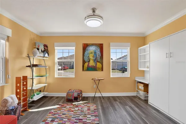 a living room with patio furniture and a floor to ceiling window
