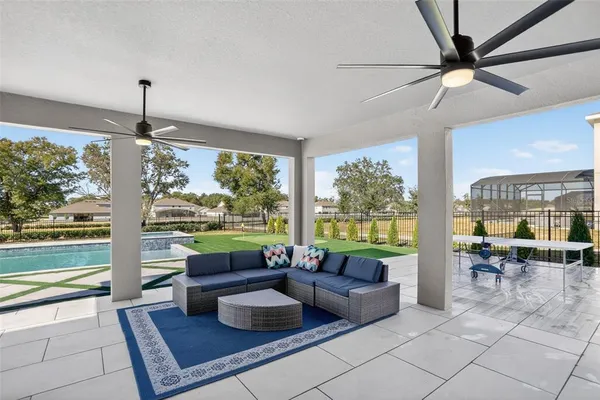 a view of a big house with a big yard and large trees