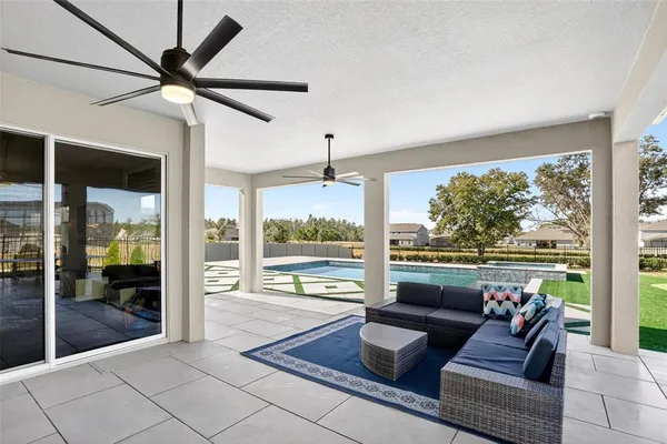 a living room with patio furniture and a large window