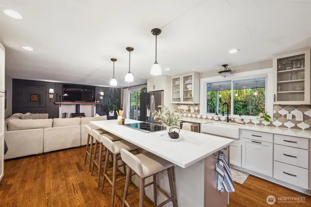 a living room with furniture large window and a fireplace