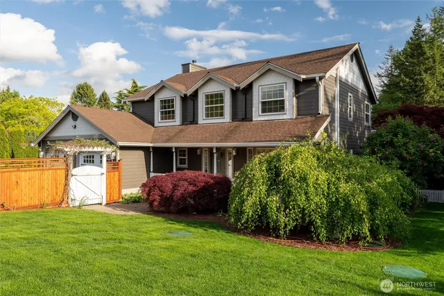 a front view of a house with a garden and plants