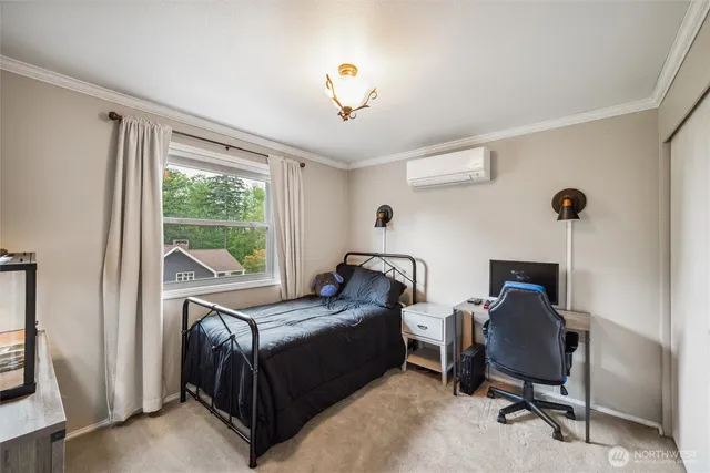 a bed room with a bed and a television