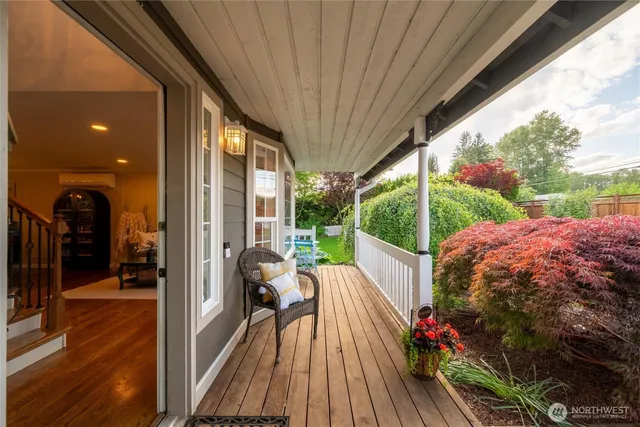 a view of a balcony with chair and wooden floor
