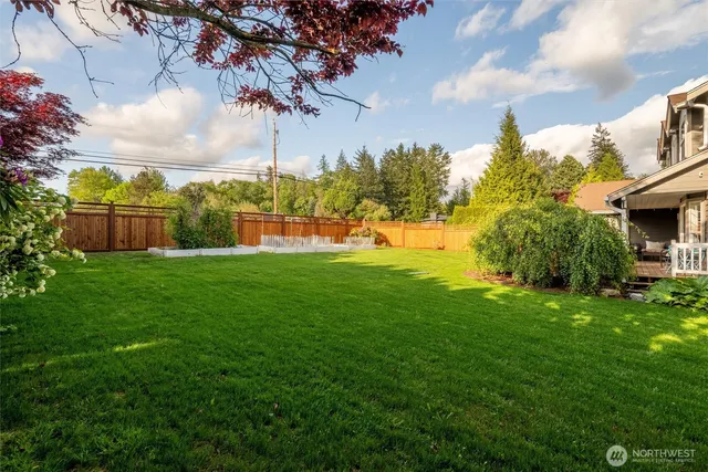 a view of a house with a yard and deck