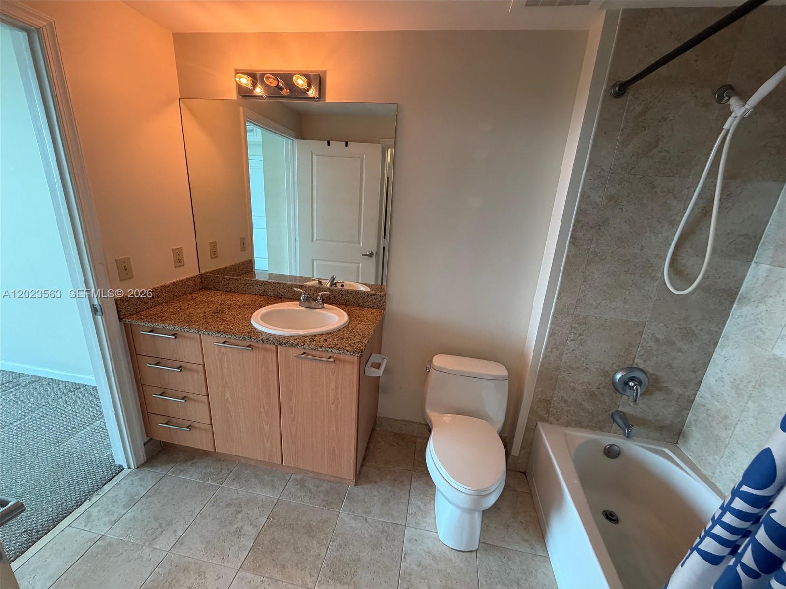 2021 Southwest 3rd Avenue, Unit 902 Miami, FL 33129 - Photo 6 of 14 a bathroom with a granite countertop sink toilet and shower